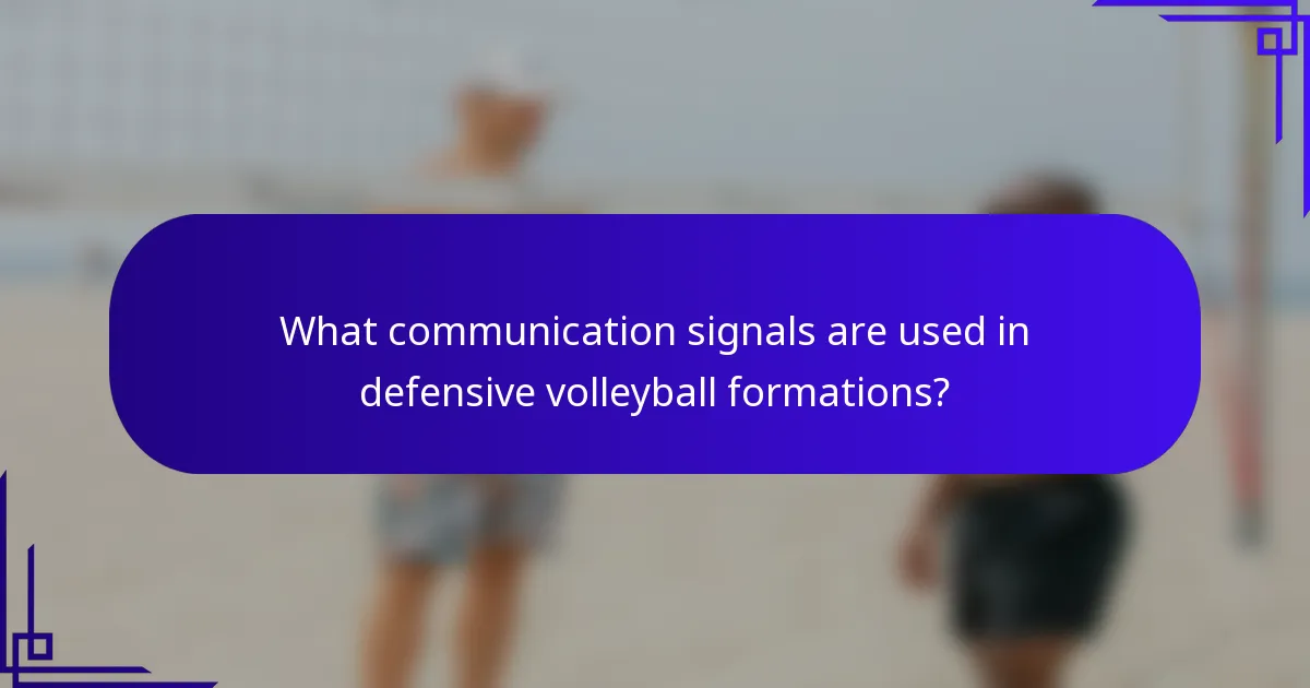 What communication signals are used in defensive volleyball formations?